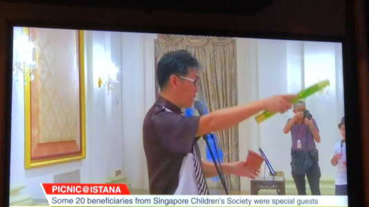 Mr Bottle on Channel News Asia demonstrating the magic which he is about to teach the children.