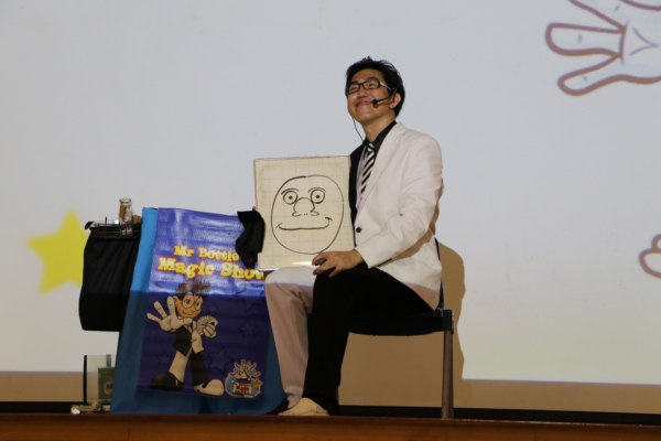 Mr Bottle magician performing his magic drawing board