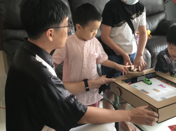 kids playing with the cardboard craft