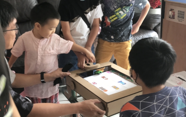 kids playing with the cardboard craft